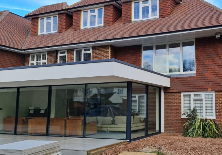 Contemporary house extension with glass façade in Weybridge by Art & Build Ltd construction company