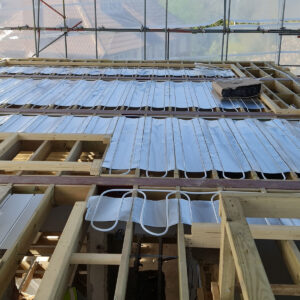 Underfloor heating pipework installation across the new floor structure in Weybridge