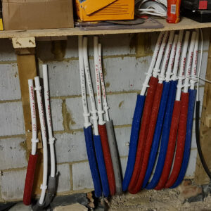 Labelled plumbing pipework prepared for a manifold by Croydon-based builders Art & Build Ltd in Weybridge