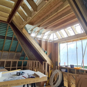 Open loft conversion space under construction within the new timber roof in Weybridge
