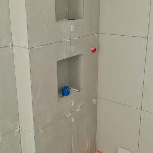 Bathroom wall niches constructed during the Weybridge refurbishment by a Croydon-based construction company