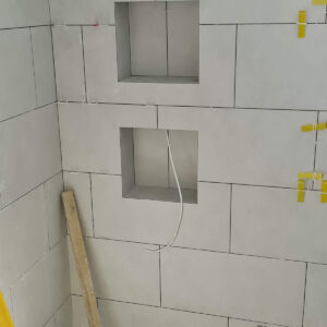 Built-in bathroom wall niches tiled during the Weybridge house refurbishment