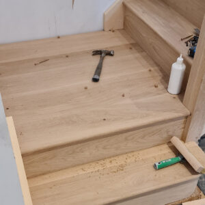 Oak staircase installation during the Weybridge refurbishment by Croydon-based builders Art & Build Ltd