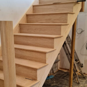 Completed oak staircase installation in Weybridge by Croydon-based builders Art & Build Ltd