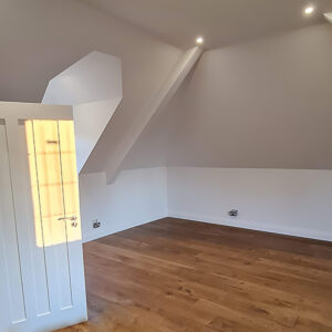 Loft bedroom with oak flooring completed by Croydon-based construction company Art & Build Ltd