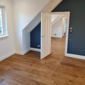 Finished loft bedroom created during the Weybridge refurbishment by Croydon-based builders Art & Build Ltd