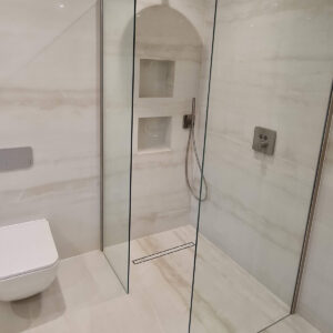 Frameless glass shower enclosure installed by Croydon-based construction company Art & Build Ltd