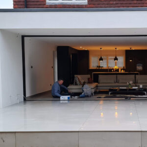 Open-plan kitchen extension with sliding doors completed by Art & Build Ltd in Weybridge