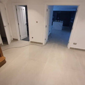 Completed hallway with oak staircase and access to the new kitchen by Croydon-based builders Art & Build Ltd in Weybridge