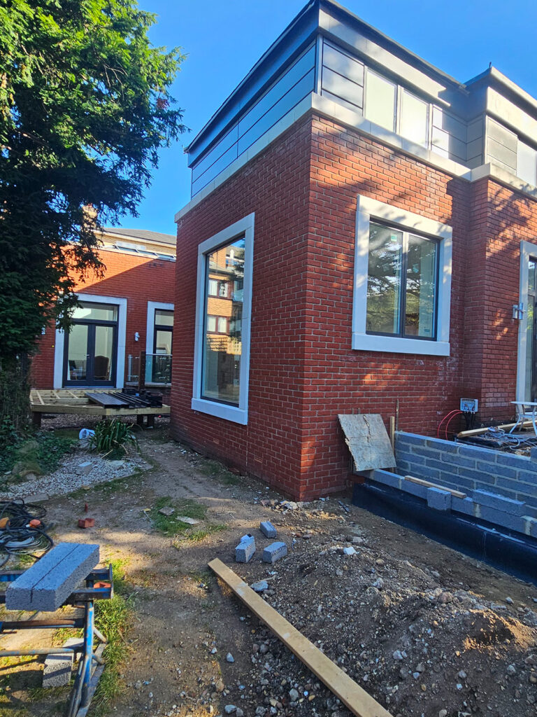 Modern brick house extension with large windows – by Art & Build Ltd, London building company, Wimbledon.