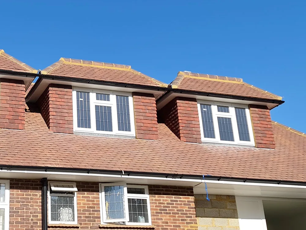 Loft conversion with red brick dormer windows in Weybridge constructed by building company Art & Build Ltd