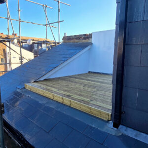 Finished rear dormer with slate cladding and timber roof terrace, by Art & Build Ltd, Croydon builders serving South London