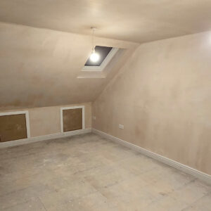 Newly plastered loft bedroom with rooflight and low-level eaves storage, by Art & Build Ltd, Croydon builders serving South London
