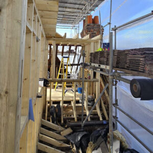 Loft conversion construction with scaffolding and timber framework on Byegrove Road