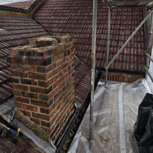 Existing tiled roof and brick chimney before loft conversion alterations, by Croydon-based builders Art & Build Ltd