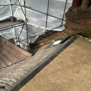 Brick parapet, chimney and prepared roof deck during loft construction, by experienced builders based in Croydon