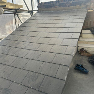 Grey slate tiles installed on the sloping exterior of a rear dormer, by Art & Build Ltd, Croydon builders serving South London