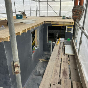 Rear dormer with slate-clad walls and exposed timber roof joists, by Croydon loft conversion builders Art & Build Ltd