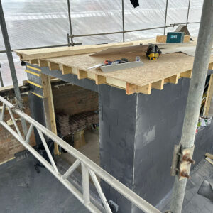 Rear dormer with slate walls and projecting timber roof joists under construction, by Art & Build Ltd, a Croydon-based construction company