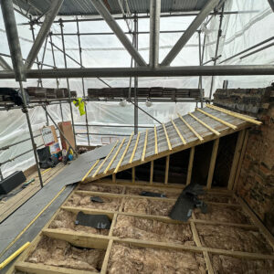 Existing roof opened to expose rafters and insulation during loft conversion works, by Croydon loft conversion builders Art & Build Ltd
