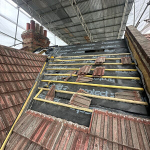 Breathable roofing membrane and timber battens installed beside existing roof tiles, by Art & Build Ltd, a Croydon-based construction company