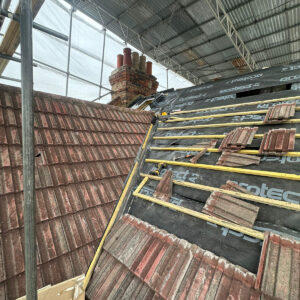 Roofing membrane and timber battens fitted around an existing brick chimney, by experienced builders based in Croydon