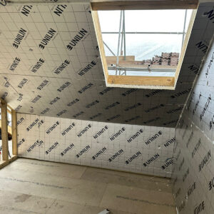 Pitched loft roof fitted with insulation and a new roof window, by the Croydon-based team at Art & Build Ltd