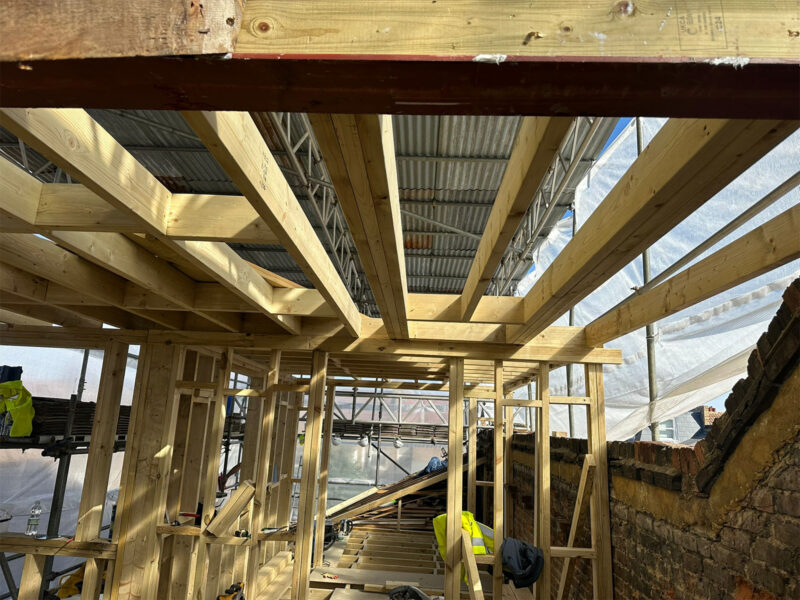 Structural timber roof and dormer framing viewed from inside the loft, by Croydon loft conversion builders Art & Build Ltd