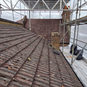 Existing tiled pitched roof and brick chimney before dormer construction, by experienced builders based in Croydon