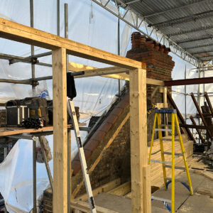 New timber wall framing constructed around the loft floor and chimney in Southwark