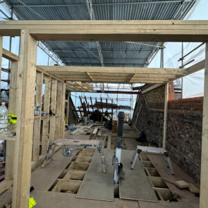 Timber doorway and wall framing forming the future corridor and rooms of a Southwark loft conversion