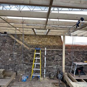 Wide view of timber joists forming the flat roof of a new dormer in Southwark SE17
