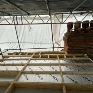 New timber joists forming the flat roof structure of a dormer loft conversion in South London