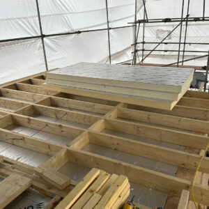 Roof insulation being installed within the dormer structure during loft conversion in Croydon