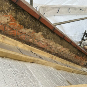 Rigid insulation fitted between timber roof rafters during a loft conversion in Southwark