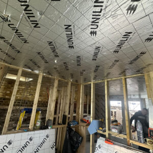 Foil-backed insulation installed across the loft ceiling and walls during first-fix works in Southwark