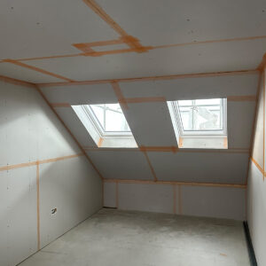 Completed plasterboard shell of a new loft bedroom with two rooflights in Southwark