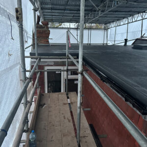 Side view of the completed L-shaped dormer flat roof and external wall finish in Southwark