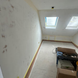 Long loft room with two rooflights after plastering and before final decoration in Southwark