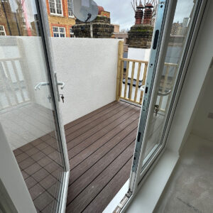Open glazed doors leading from the loft bedroom onto a newly built roof terrace in Southwark