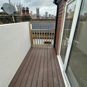 New roof terrace with composite decking and glazed doors leading into the loft bedroom