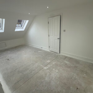 Bright completed loft bedroom with two rooflights, internal door and recessed ceiling lights in Southwark