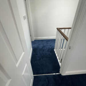Completed loft landing and staircase finished with blue carpet in Southwark
