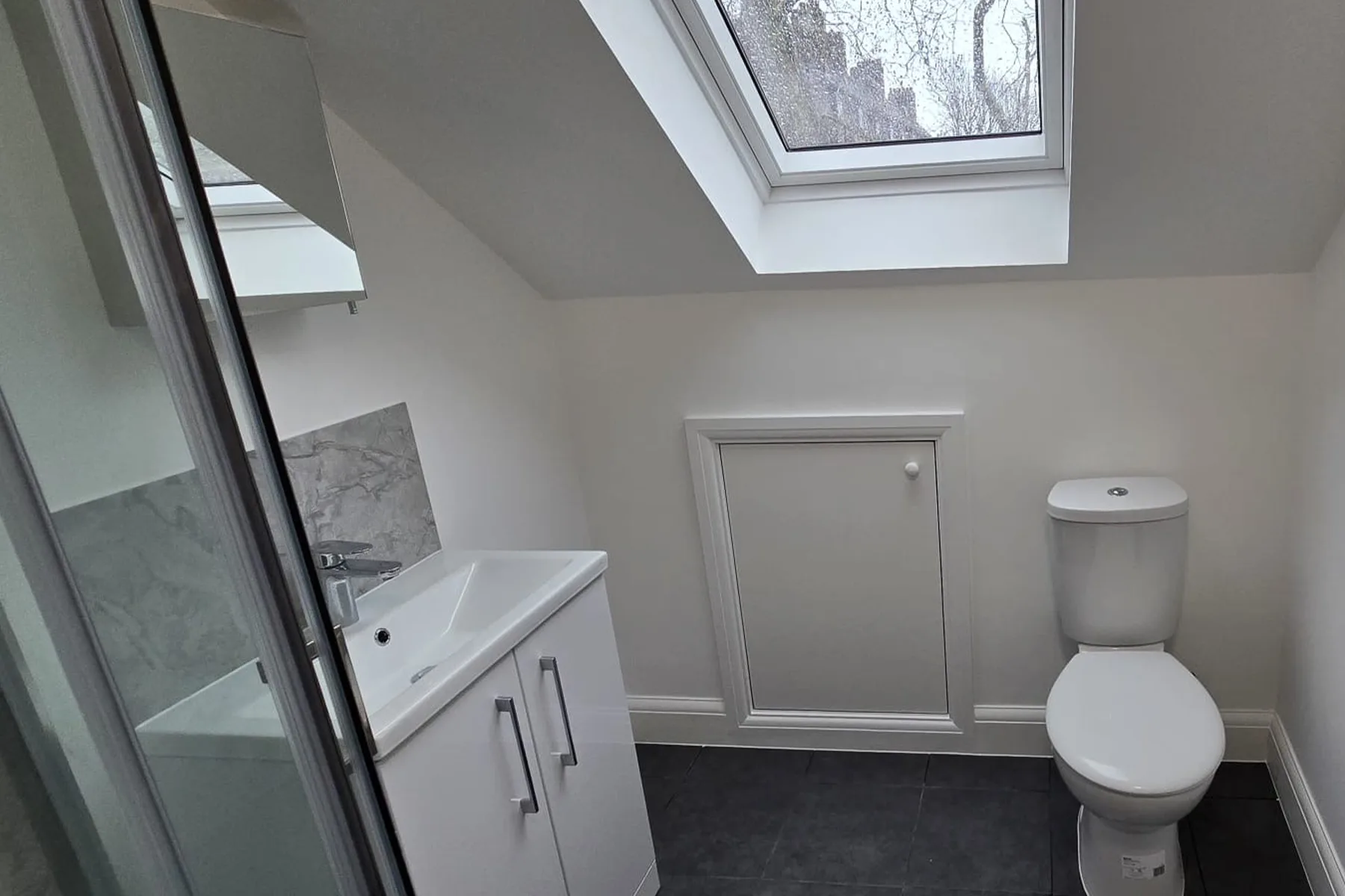 Loft en-suite bathroom with rooflight after loft conversion in Croydon