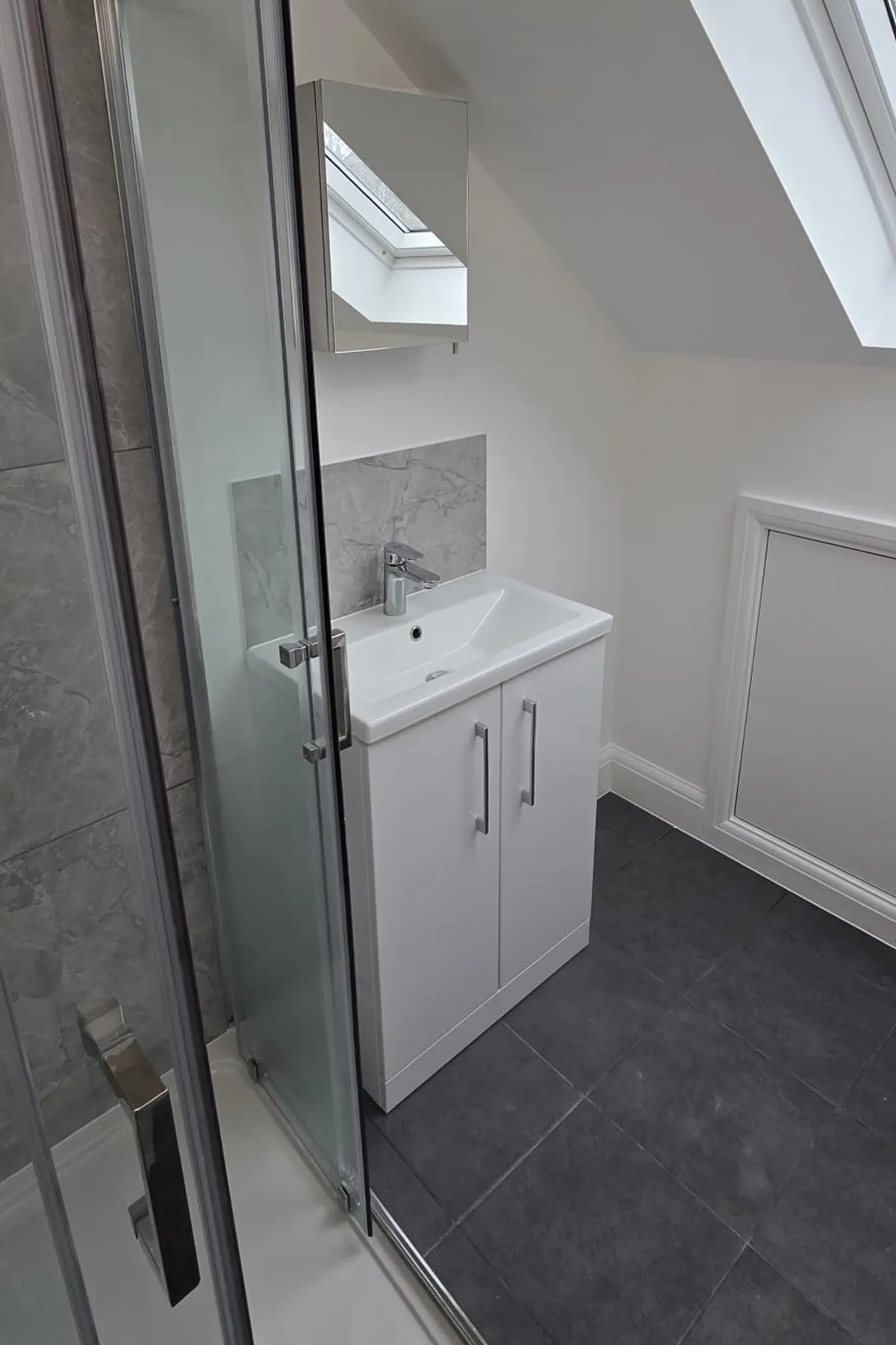 Vanity unit and shower area in loft en-suite bathroom after Croydon loft conversion