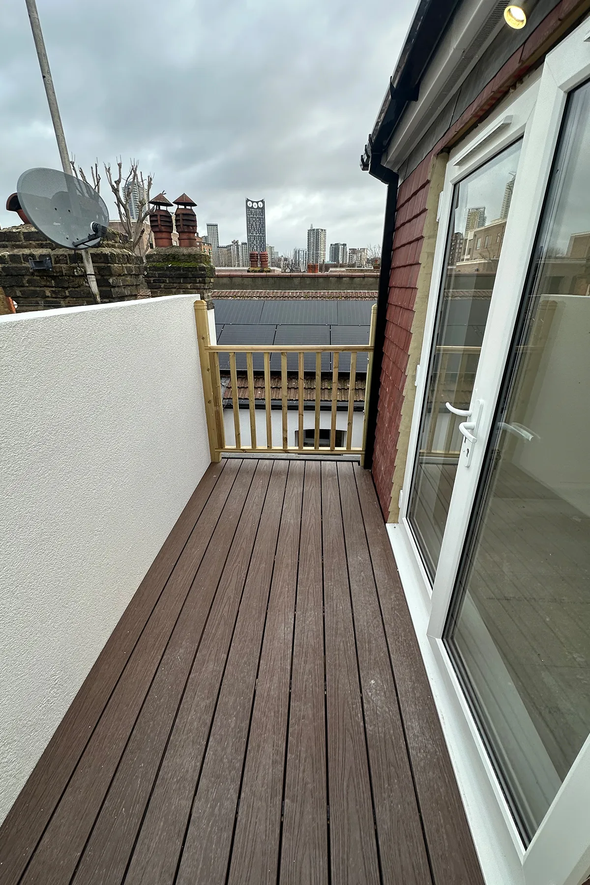 Roof terrace area with white parapet wall during loft conversion in Croydon