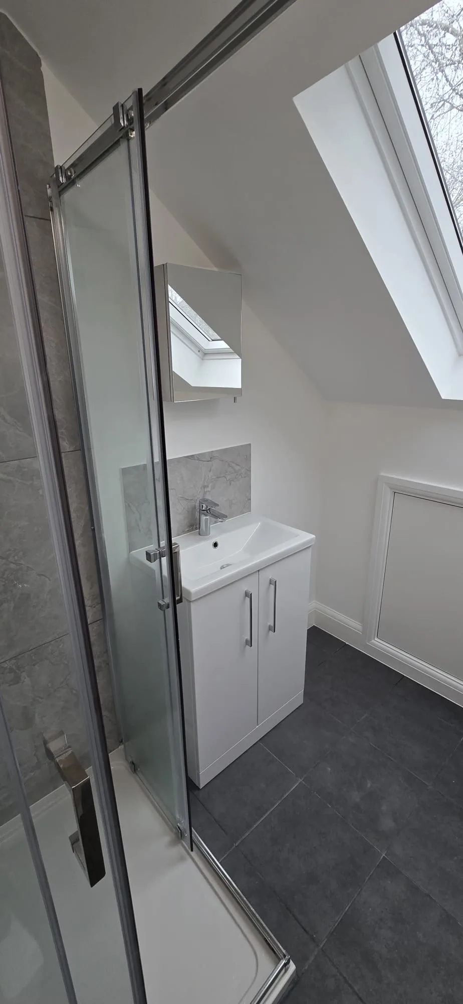 Loft conversion ensuite bathroom with Velux window by Art & Build Ltd in Croydon and South London