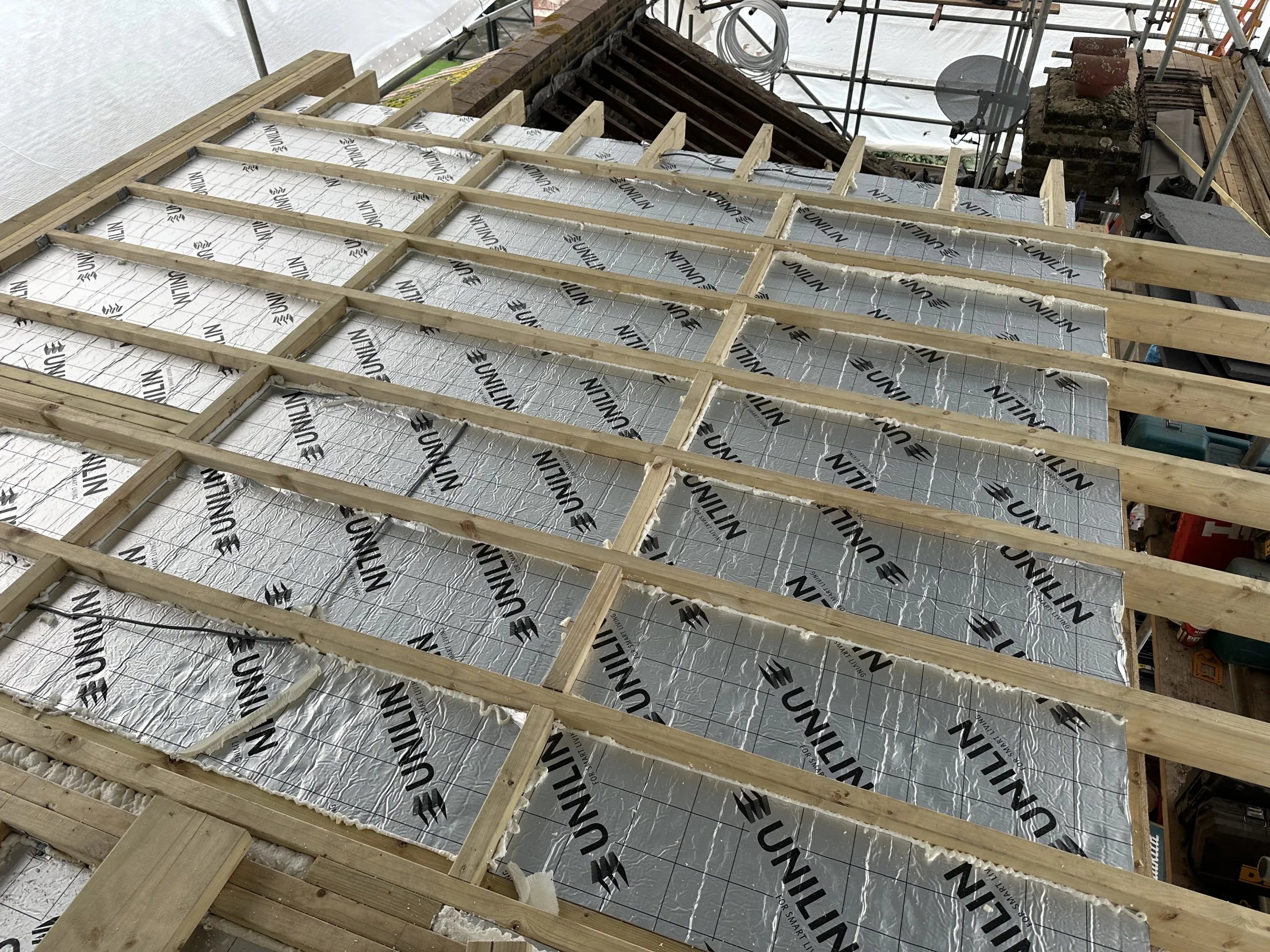Loft insulation installed between joists during a conversion project by Art & Build Ltd in South London