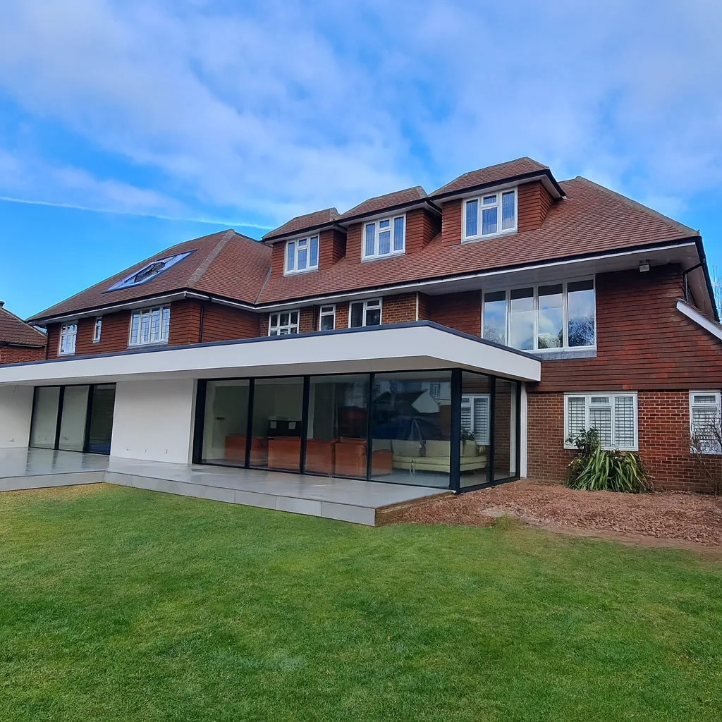 Completed house extension and loft conversion by Art & Build Ltd with modern rear glazing and landscaped garden