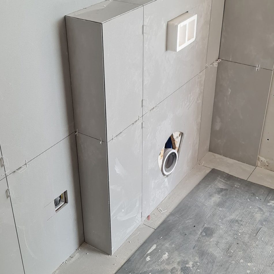 Wall-hung toilet frame and concealed cistern installed during the Weybridge bathroom refurbishment